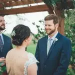 bride and groom getting ready to say their vows to each other during wedding ceremony at Kelly Farms